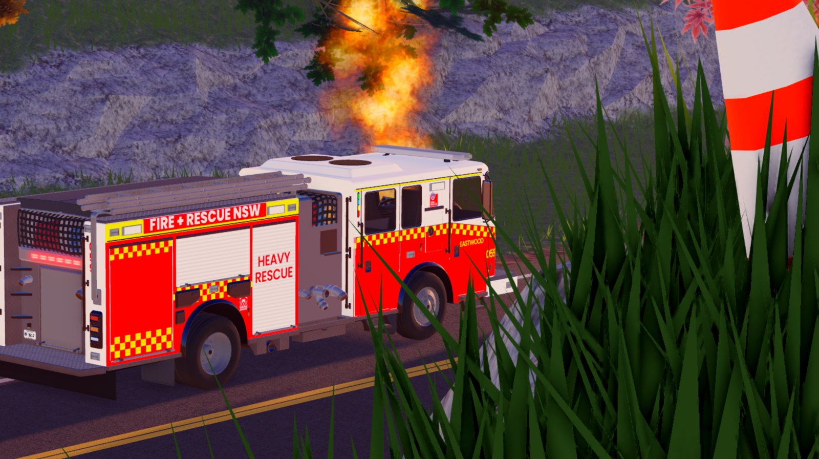 Fire and Rescue NSW heavy rescue truck beside a hillside fire